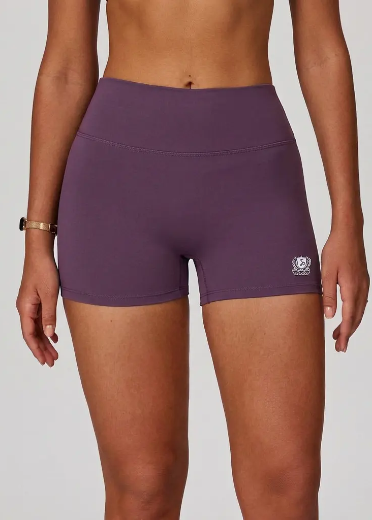 Purple athletic shorts worn by a person on a plain background
